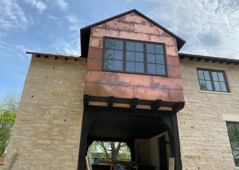 Copper metal panel facade on a stone building for Skylight Installation in North Augusta